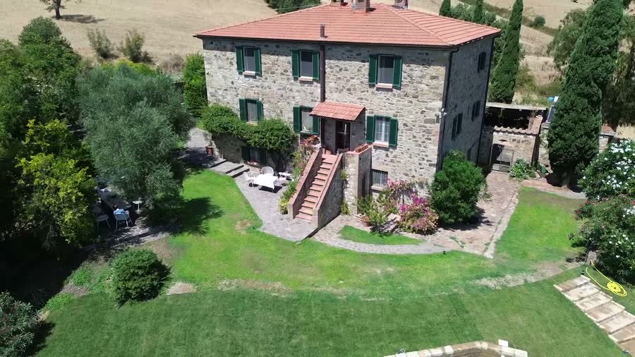 Aerial view of the house with lawns and terraces around it