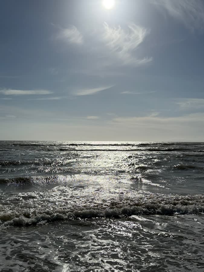 Sunlight on the sea with waves breaking towards the shore