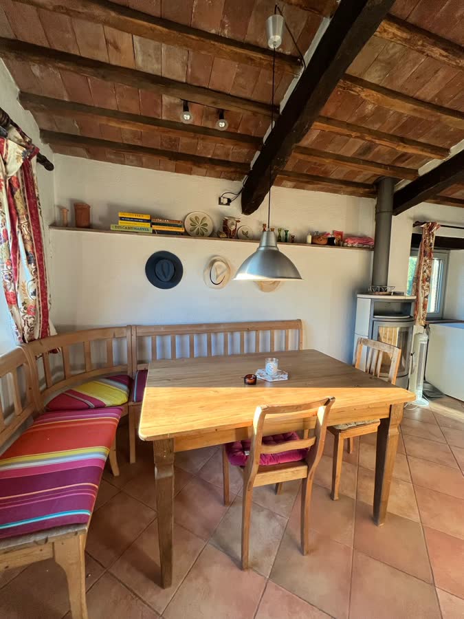 The kitchen and dining area with beamed ceiling and terracotta floor