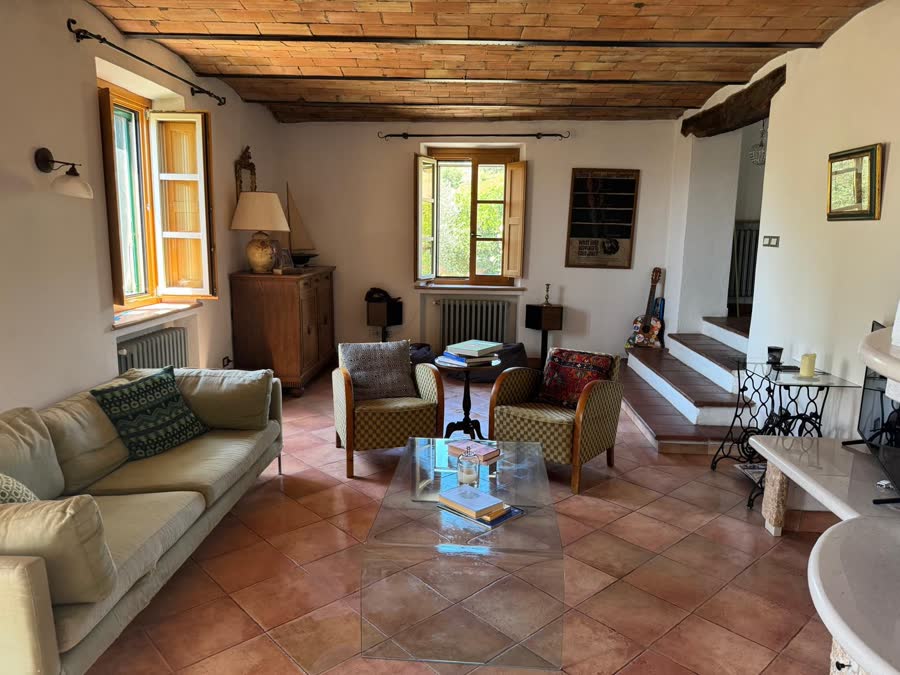 Second sitting room with sofas, armchairs and a beamed ceiling